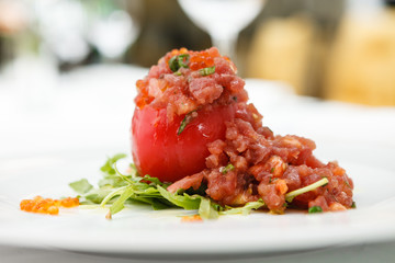 Tuna tartar with tomato served on a plate