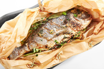 Baked dorado fish in parchment