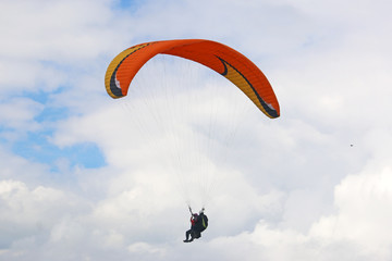 Tandem Paraglider flying wing in a blue sky	