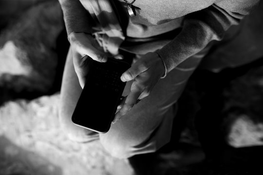 Close up photo of female hands holding mobile phone and texting. 
