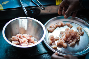 man cooking chicken in a pan in kitchen, Indian Non veg food