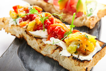 Delicious bruschetta with baked peppers closeup view