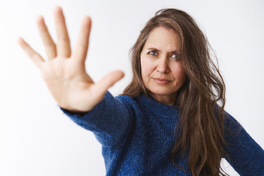 Stop Right There Young Lady. Displeased Strict And Bossy Female Parent In 50s Pulling Palm Towards Camera In Forbid Gesture Looking Displeased And Dissatisifed, Restricting And Forbidding Something