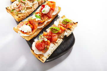 Bruschetta with baked tomatoes closeup view