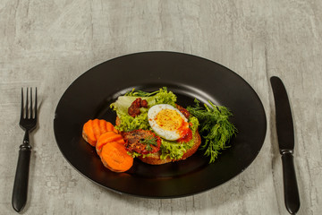 Fresh boiled egg with lettuce, parsley and dill. Healthy nutrition. Morning breakfast. Healthy organic natural food concept. View from above