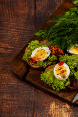 Fresh boiled egg with lettuce, parsley and dill. Healthy nutrition. Morning breakfast. Healthy organic natural food concept. View from above