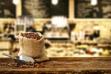 fresh coffee on brown desk and cafe interior 