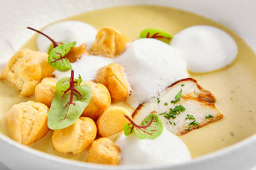 Wild mushroom cream soup with cheese profiteroles