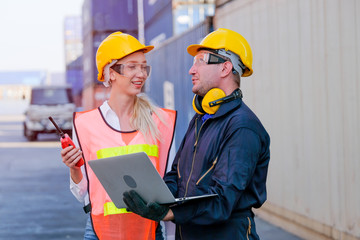Worker man and woman discuss about their system and express happy emotion in cargo container shipping area.