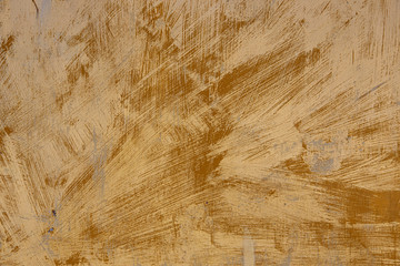 An old, rusty, colored plate with traces of background painting