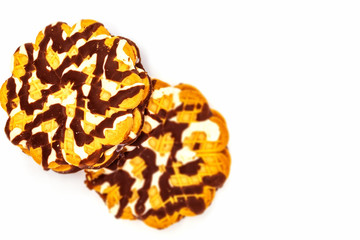 On a white background lies a fresh sugar treat for tea, a double sweet cookie with filling