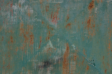 An old, rusty, colored plate with traces of background painting