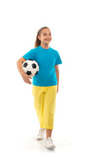 Shot  of a positive smiling girl  walking with ball, isolated