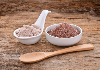 Black salt on wooden background