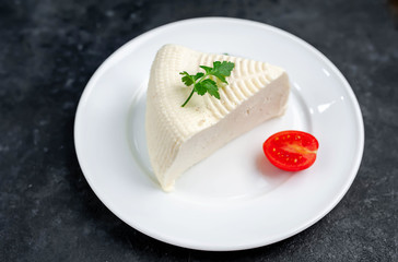 feta cheese on white  plate on stone background