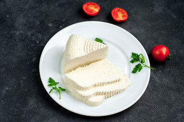 feta cheese on white  plate on stone background