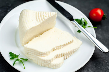feta cheese on white  plate on stone background