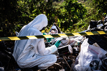 Asian scientist wear Chemical protection suit check danger chemical,working at dangerous...