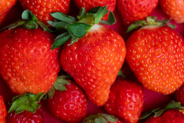 Fresh strawberries in white porcelain plate on wooden table