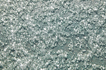 Graupel, snow pellets or soft hail texture, background. Form of precipitation, macro