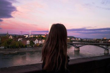 Fototapeta na wymiar Gilr is looking for sunset in swiss Basel