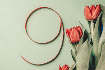 red silk ribbon shaped number nine, with tulips flower