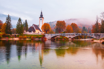 Beautiful autumn colors at Bohinj Lake at sunrise in Triglav National Park