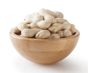Raw peanuts in wooden bowl isolated on white background with clipping path