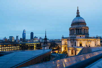 View of St. Pauls Cathedral and evening London cityscape during dusk on cloudy day