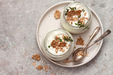 Natural homemade organic yogurt with granola and oatmeal in glass jars