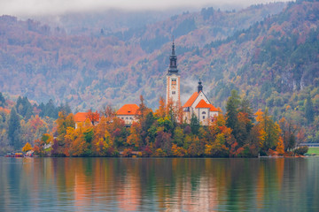 Fototapeta premium Famous Bled Lake in Triglav National Park in the Julian Alps with a forest in autumn colors