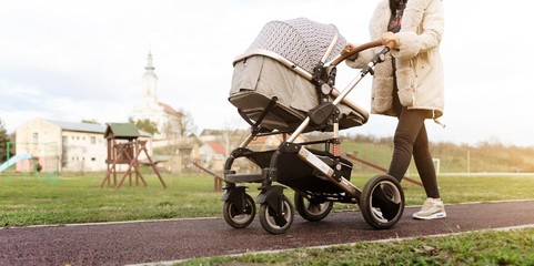 mother with baby carriage. woman with baby trolley isolated