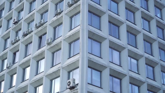 Corner of a Soviet administrative building with perfect square Windows. Grandiose buildings of the Soviet Union. House of design organizations . Close up.