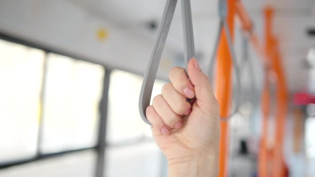 A man holds a handrail in public transport. Metro, bus, tram