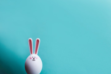 hare on a blue background. Minimal Easter concept