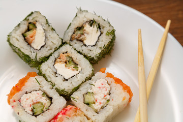 rolls with dill and salmon with soy sauce, ginger and chopsticks.