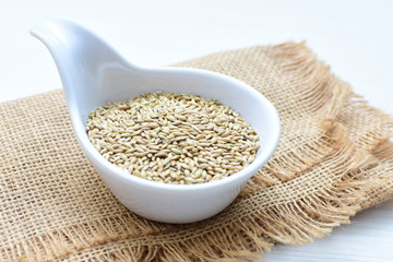 birdseed seeds, food for birds, displayed in containers on cloth bottom