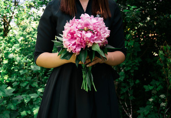 a girl holds a bouquet
