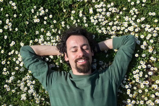 man in a filed of daisies