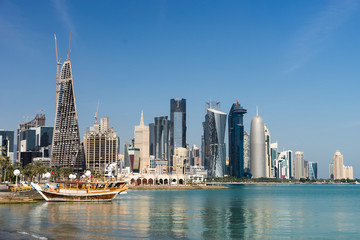 Skyscrapers in the city center with water and boat foreground of Doha, Qatar 2020.