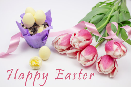 Happy easter card. Multi-colored Easter eggs with tulips on a white background. Isolate Banner. Tulips. Copy space