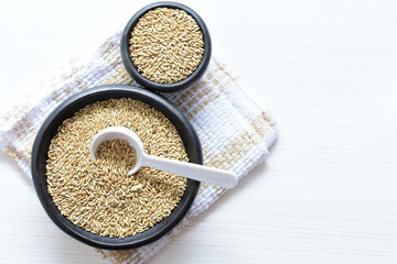 birdseed seeds, food for birds, displayed in containers on cloth bottom