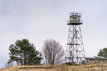 Abandoned military watch tower on small cape on the shore of Finnish Gulf (Baltic Sea, North Europe). Rusted iron framework is partially missing that makes construction dangerous.  Beautiful nature.