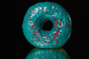 Blue Donut isolated on a black background. Close up.