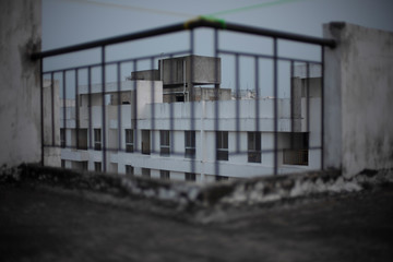 Blurred image of grills/railings of a rooftop/balcony in cloudy sky background.