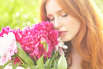 Fototapeta premium summer closeup portrait of a young redhead woman with flowers