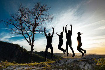 Silhouette of people. People in jump. Friends have fun at sunset. Funny friends. Best friends. Friends traveling. Group of people at sunset. People have fun at sunset. Travelers at sunset