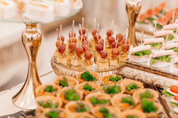 Original appetizer of canap with salted herring and cards of the potato. Rustic. Close-up.wedding...