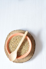 Seed of birdseed, food for birds, displayed in containers on white wooden background