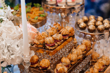 Original appetizer of canap with salted herring and cards of the potato. Rustic. Close-up.wedding...